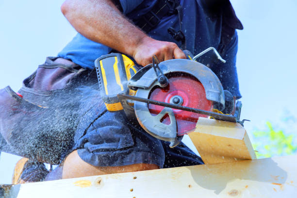 istock Skilled carpenter using circular saw to cut wood at construction site during sunny day 2196308566