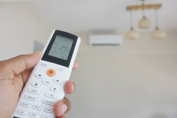 istock Close up of man hand holding air condition remote. 2196308832