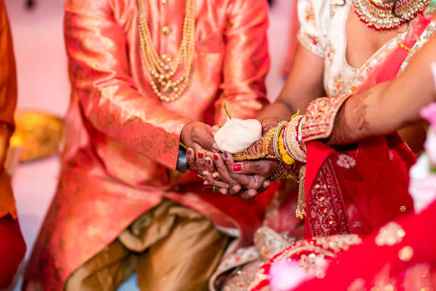 istock Indian Hindu wedding ceremony ritual items hands close up 2196311690