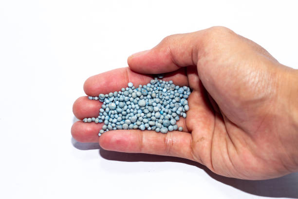 istock hand holding blue chemical fertilizer granules 2196314100