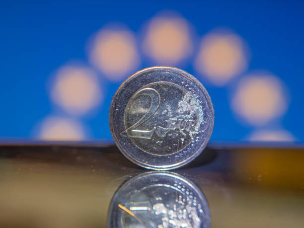 istock Two Euro Coin Reflecting Against Colorful Background 2196318029