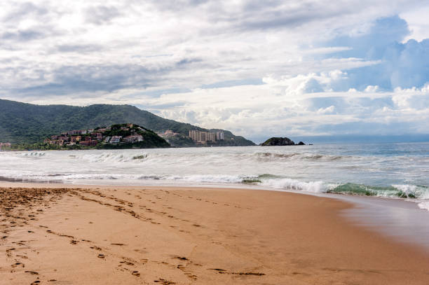Mexico, Nayarit State, Bucerias. Palm trees and beach looking Southeast to resort hotels in Puerto Vallarta.