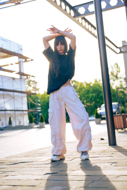 istock Stylish dancer showcasing contemporary moves outdoors during sunset in an urban setting 2196324469