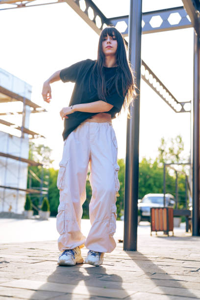 istock Dancer performs urban choreography outdoors in casual attire during golden hour 2196324637