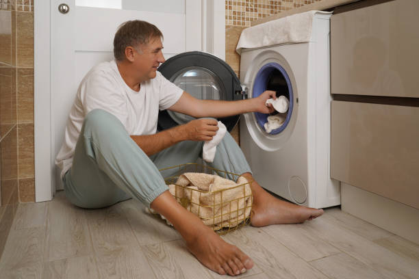 istock person loading a towel into a modern washing machine during a laundry day at home 2196325960