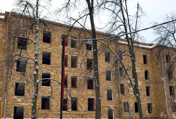 istock A large brick building with a red and white flag on the side 2196328115