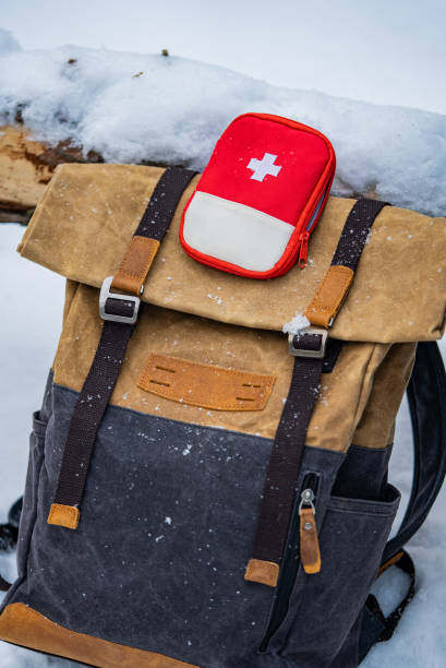 istock Backpack and first aid kit lying on snow during winter trip 2196333218
