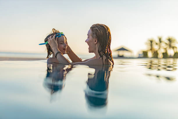 istock Happy single mother and her son talking in the pool. 2196333315
