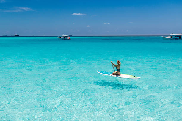istock Young woman enjoying while paddleboarding in summer day at sea. 2196333671