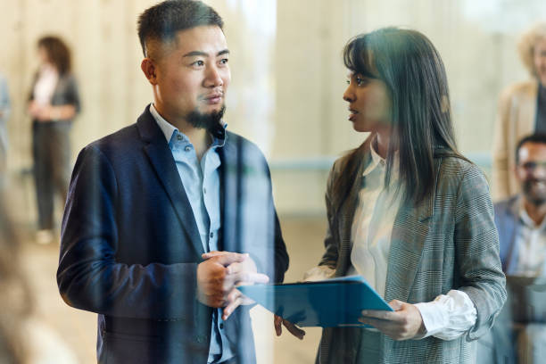 istock Diverse entrepreneurs talking about reports in a hallway. 2196335138