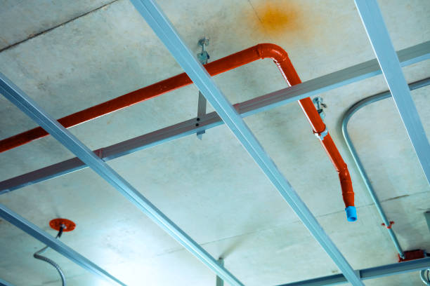 istock Fire hose in ceiling structure, public utility systems, room on the building before decorating. Empty and functional area. 2196337395