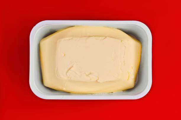 Just opened margarine box on red background. Seen direktly above.
