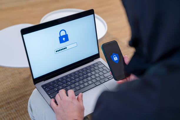 istock Hacker breaking password with laptop and smartphone 2196340375