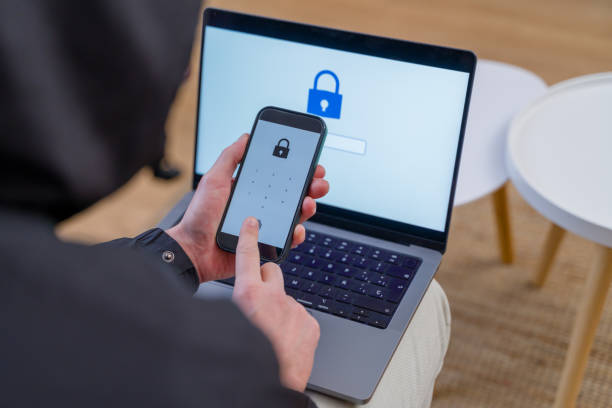 istock Hacker breaking password on laptop and smartphone 2196340392