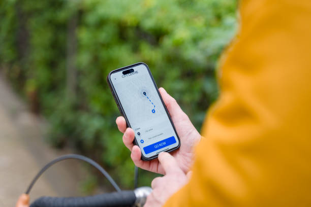 istock Cyclist using GPS navigation app on smartphone to reach city center 2196341584