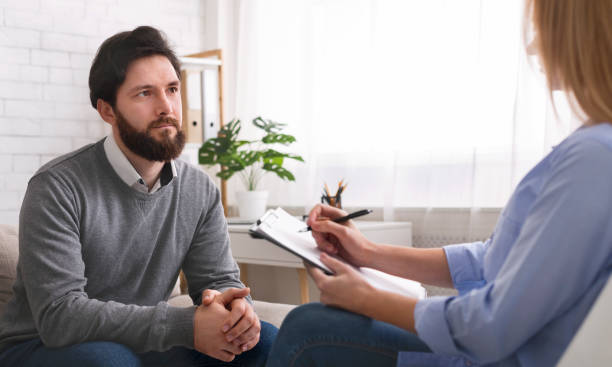 istock Millennial man talking to specialist at therapy session 2196342271