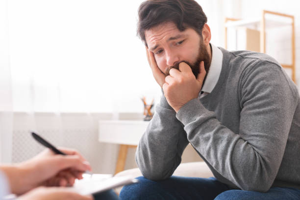 istock Millennial man with depression during psychotherapy session 2196342295