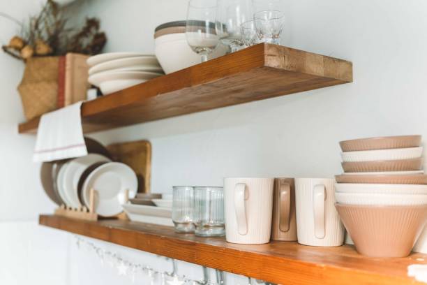 istock Wooden shelf with Glass, coffee cup, plate, bowl various cookware and decoration in kitchen. Hanging storage. Organization kitchen room concept 2196343345