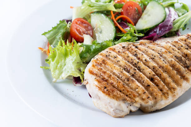 istock Grilled chicken with salad isolated on white background 2196346814