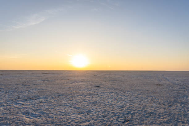 istock pristine sunset over white salt flats desert with dramatic orange sky at dusk 2196346982