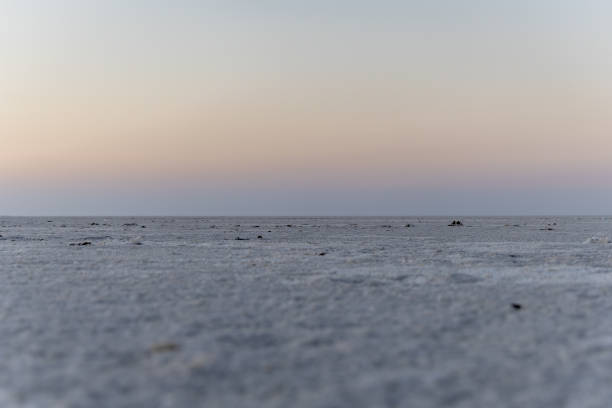 istock white salt flats desert with dramatic orange sunset sky at dusk 2196347059
