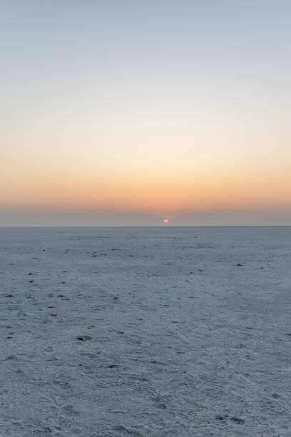 istock white salt flats desert with dramatic orange sunrise sky at dawn 2196347484