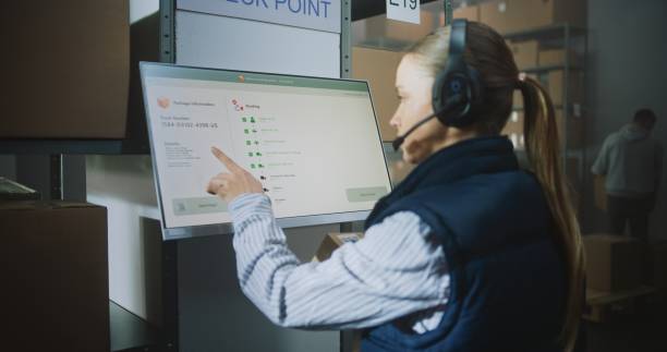 istock Female Logistics Manager Talks on Headset, Scans Parcel in Tracking App at Postal Terminal 2196349704