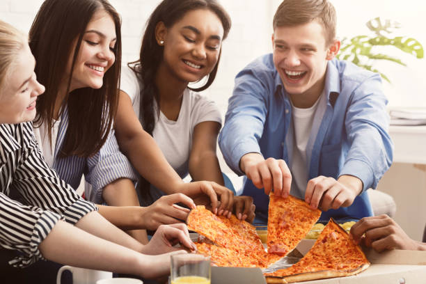 istock Friends eating pizza, spending time together at home 2196350725