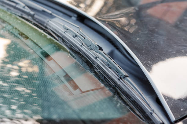 istock Car windshield with wipers in the body of a black car 2196351596