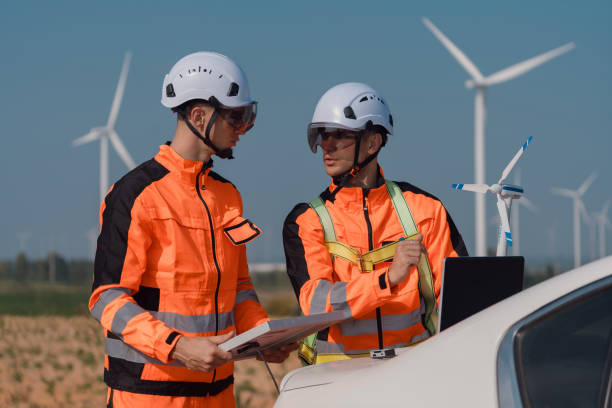 istock Surveyor and engineer Examine the efficiency of gigantic wind turbines that transform wind energy into electrical energy that is then used in daily life. 2196353187