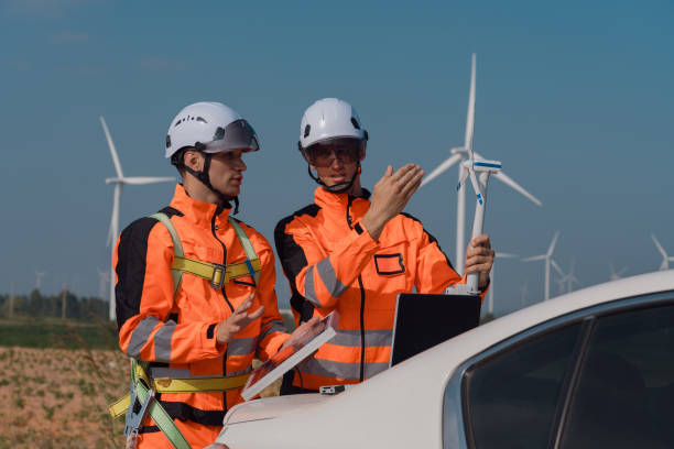 istock Surveyor and engineer Examine the efficiency of gigantic wind turbines that transform wind energy into electrical energy that is then used in daily life. 2196353189