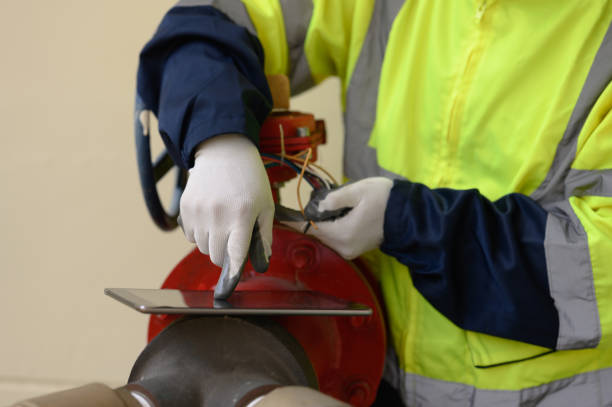 istock Close-up of engineer inspecting pipes and valves of fire pump system. 2196353190