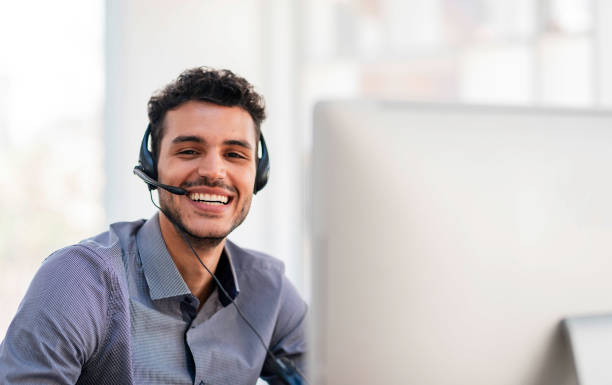 istock Smiling Customer Service Representative Wearing Headset in a Bright Office Environment 2196353223