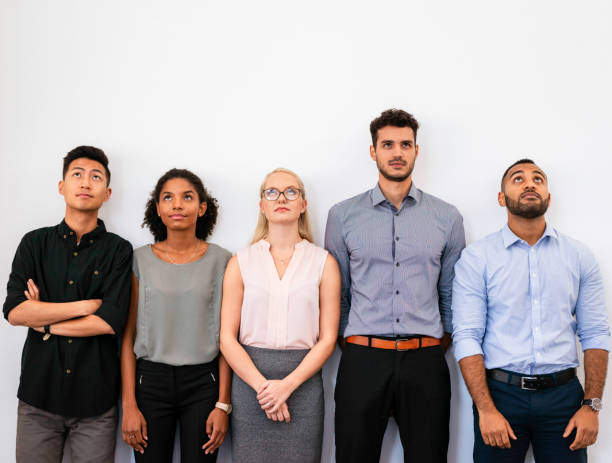 istock Diverse Group of Professionals Standing Together Looking Upward in Front of a Plain White Background 2196353792