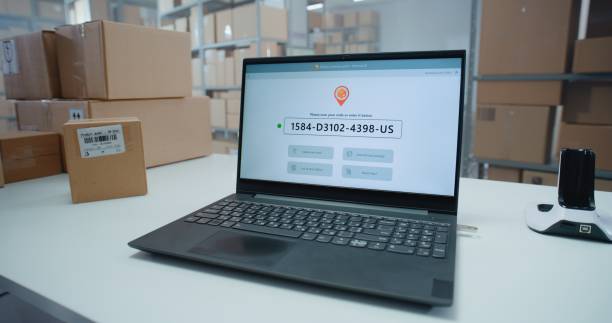 istock Logistics Specialist Scans Code to Check Parcel Routing on Laptop in Delivery Tracking Software 2196354310