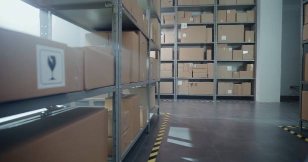 istock Warehouse Retail Center with Rows of Shelves with Cardboard Boxes and Parcels 2196357105