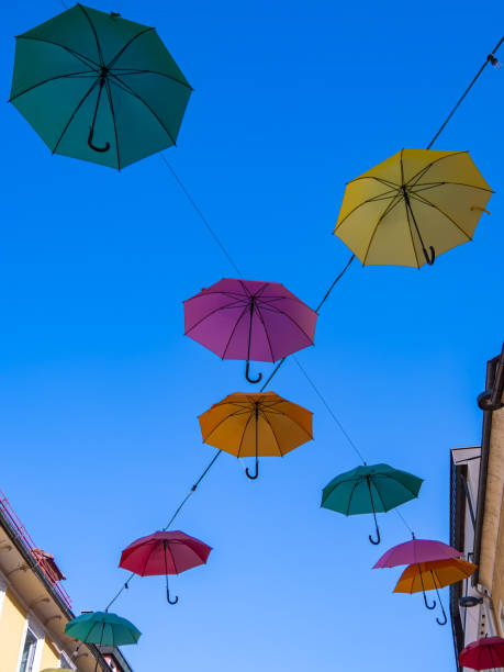 istock Colorful umbrellas suspended between building 2196358971
