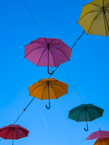 istock Colorful umbrellas against blue sky in the town 2196358972
