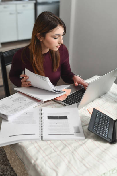 istock Medicine Student Looking Dedicated and Focused While Listening to Online Class at Home 2196359207