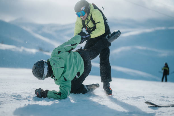 istock Two friends enjoy a snowy adventure while skiing and playing in the mountains. 2196361197