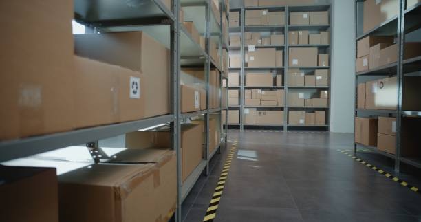 istock Warehouse Retail Center with Rows of Shelves with Cardboard Boxes and Parcels 2196361445