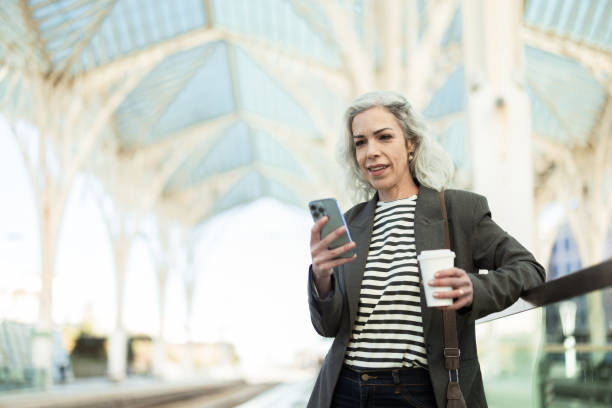istock Beautiful woman waiting for a train and using smartphone 2196362535