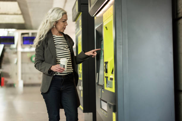 istock Woman buying a train ticket on the ticket machine 2196362581
