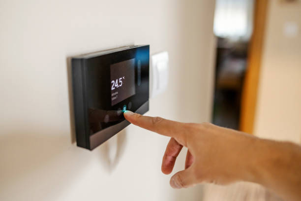 istock Close up of hand pressing temperature regulator at home. 2196363085