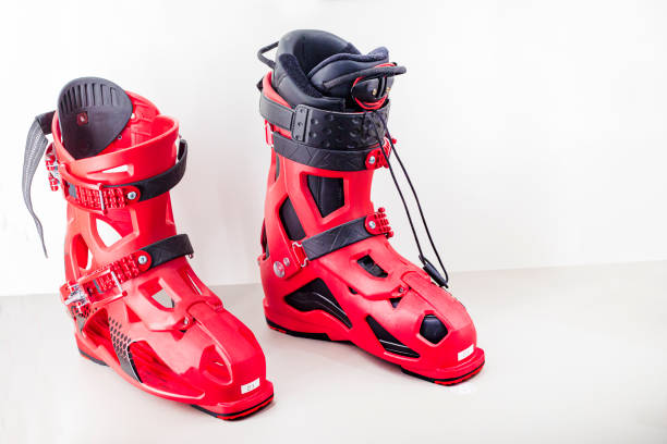 stylish designer red ski boots on a light background. Convenience and comfort