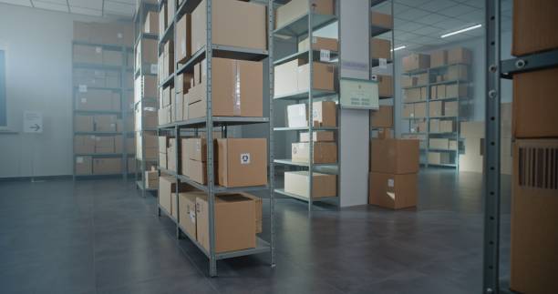 istock Warehouse Retail Center with Rows of Shelves with Cardboard Boxes and Parcels 2196367016