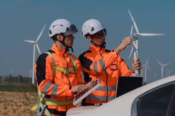 istock Surveyor and engineer Examine the efficiency of gigantic wind turbines that transform wind energy into electrical energy that is then used in daily life. 2196367217