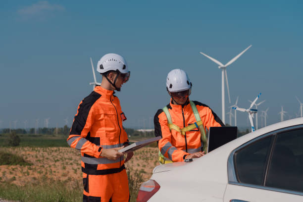 istock Surveyor and engineer Examine the efficiency of gigantic wind turbines that transform wind energy into electrical energy that is then used in daily life. 2196367219