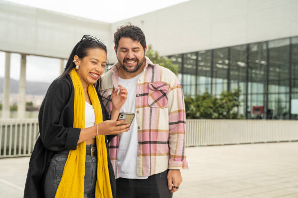 istock happy couple looking at cell phone 2196368298