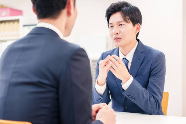 istock Businessman handling visitors at the counter 2196369518